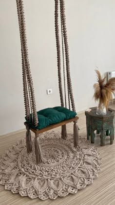 a living room with two hanging chairs and a rug on the floor