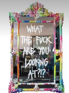 a mirror with graffiti written on it and the words what the fock are you looking at?