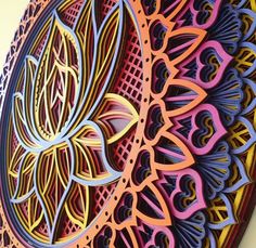 an intricately designed paper plate is displayed on the wall