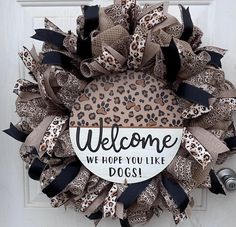 a leopard print wreath with the words welcome, we hope you like dogs on it