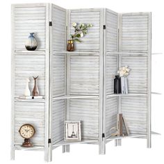 a white room divider with shelves and vases on the top one shelf is filled with books