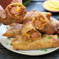 a person is holding up some food on a plate