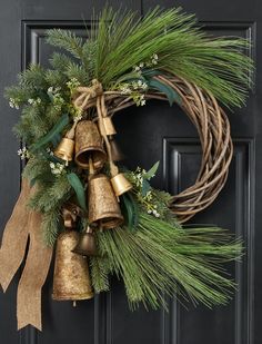 a christmas wreath with bells and greenery