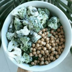 broccoli, cauliflower and chickpeas are in a white bowl