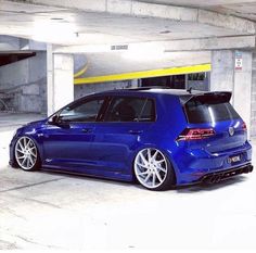 a blue car parked in a parking garage