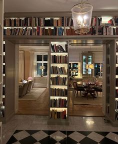 a room filled with lots of books and a chandelier