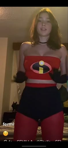 a woman in a red and black costume posing for the camera with her hands on her hips