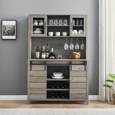 a wooden cabinet with bottles and glasses on it