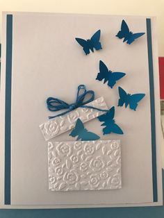 a white card with blue butterflies on it and a gift box in the middle that says happy birthday