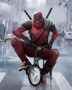 a deadpool riding a bike in the street