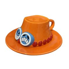 an orange hat with a face painted on the side and beads around the brim