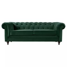 a green couch sitting on top of a white floor