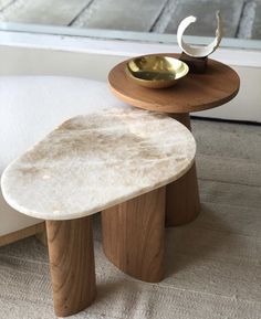 two stools sitting next to each other on top of a carpeted floor in front of a window