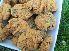 a white plate topped with cookies on top of green grass