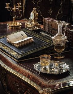 a table topped with books and glasses filled with liquid