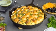 a pan filled with food sitting on top of a table next to other ingredients and utensils