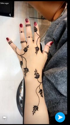 a woman's hand with hendix on it and flowers painted on the palm