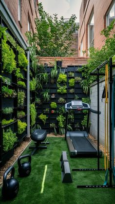 an outdoor gym with artificial turf and plants on the walls, along with exercise equipment