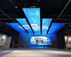 a large projection screen in the middle of a room