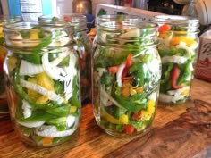 several mason jars filled with different types of vegetables