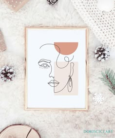 a framed art print with a woman's face on it and other holiday decorations