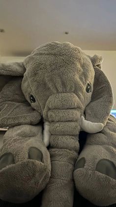 an elephant stuffed animal sitting on top of a desk