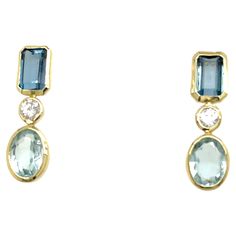 Elegant drop earrings in 14ct yellow gold, showcasing stunning aquamarine and blue topaz gemstones accented by sparkling diamonds. A graceful blend of color and brilliance. Total Diamond Weight: 0.12ct Diamond Colour: H Diamond Clarity: SI1 Total Weight: 2.69g Earrings Size: 20mm x 6mm SMS9700 Yellow Gold Drop Earrings, Blue Topaz Stone, Pink Topaz, Peridot Gemstone, Topaz Stone, Aquamarine Blue, Diamond Drops, Modern Earrings, Gold Drop Earrings