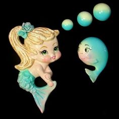 there is a little mermaid next to a small fish and bubbles on the black background