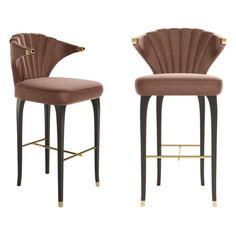 a pair of bar stools with shell backrests and gold trim on the legs