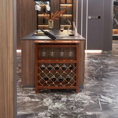 a wine rack in the middle of a room next to a counter with bottles and glasses on it