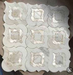 white marble tile with flower design on the top and bottom, in various sizes and colors