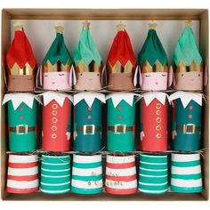 a box filled with lots of different colored paper wrapped christmas hats on top of each other