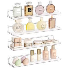 three clear shelves holding different types of perfumes