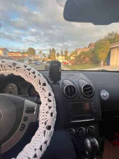 the steering wheel cover is crocheted with white yarn