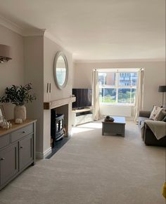 a living room filled with furniture and a fire place