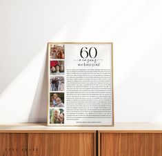 a poster on top of a wooden cabinet in front of a white wall with the number 60