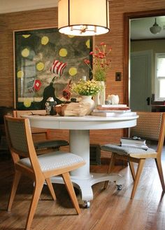 a dining room table with two chairs around it