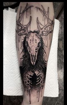 a black and white tattoo with an animal's head in the middle of it