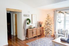 a living room filled with furniture and a christmas tree