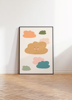 an art print on the wall in a room with wood floors and white walls, featuring clouds