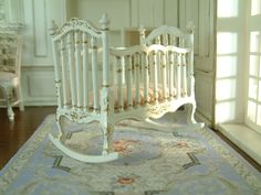 a baby crib sitting on top of a wooden floor next to a door and window