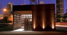 an open book case in front of a cityscape with skyscrapers at night