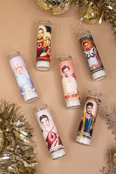 several candles are sitting on a table next to some tinsel