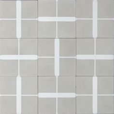 a white and gray tiled wall with several squares on one side, two lines on the other