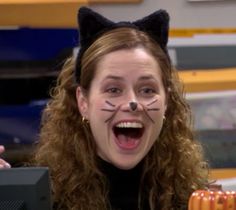 a woman with her mouth open and cat ears on