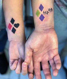 two people with matching tattoos on their hands