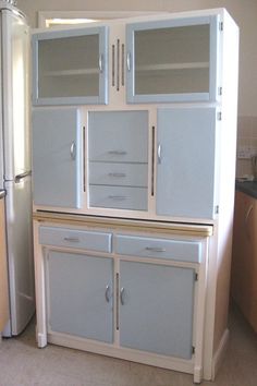 a kitchen with an old fashioned refrigerator and cabinets