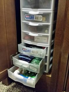 an organized drawer in the corner of a kitchen