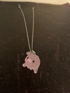 a necklace with a pink pig on it