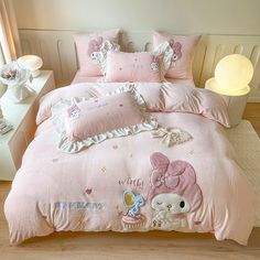 a pink comforter set with hello kitty on it